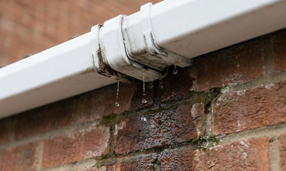 Leaking gutter joint causing water staining on brickwork — common guttering problem in Stoke-on-Trent