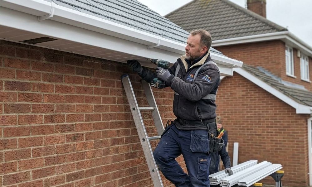 Potteries Fascias tradesman fitting new uPVC soffit panels to the eaves of a Stoke-on-Trent property