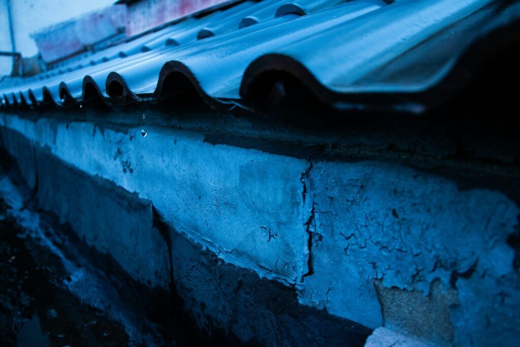 Roof and building side illuminated with blue light.